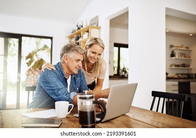 Couple With Laptop Planning Finance, Banking And Checking Retirement Budget While Becoming Debt Free At Home. Smiling, Happy And Cheerful Mature Man Showing Woman An Approved Bank Loan On Technology