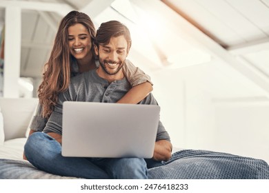 Couple, laptop and relax or embrace on bed with online search for holiday destination or discount offers on travel. People, happy or hug in bedroom in home with bonding, social media browsing or love - Powered by Shutterstock