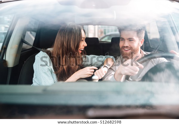 Couple laughs in car. so\
cool couple