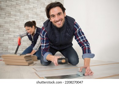 Couple Laying New Wooden Flooring