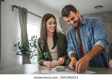 Couple learn and practice how to make a clay figurine, pottery