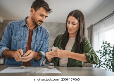 Couple learn and practice how to make a clay figurine, pottery