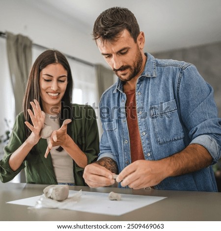 Couple learn and practice how to make a clay figurine, pottery