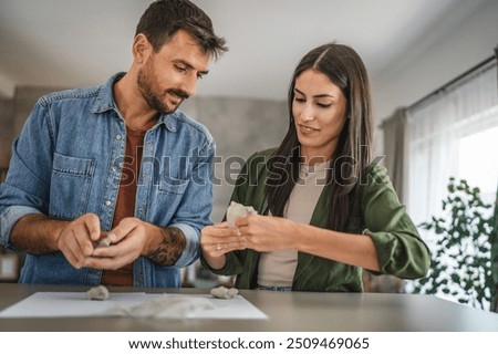 Couple learn and practice how to make a clay figurine, pottery