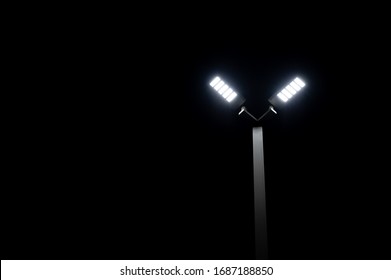 A Couple Of LED Street Light Glows Under The Night Time Dark Sky