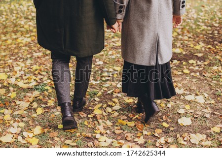 Couple legs walk in park on autumn day