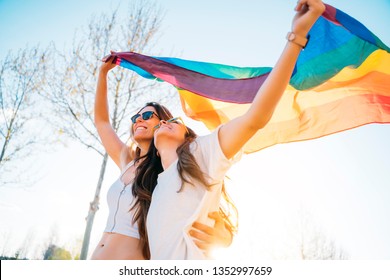 Couple Lesbian Woman With Gay Pride Flag On The Street