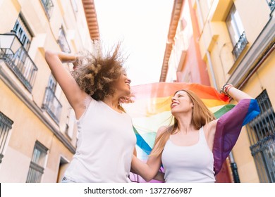 Couple Lesbian Woman With Gay Pride Flag On The Street Of Madrid City