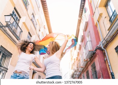 Couple Lesbian Woman With Gay Pride Flag On The Street Of Madrid City