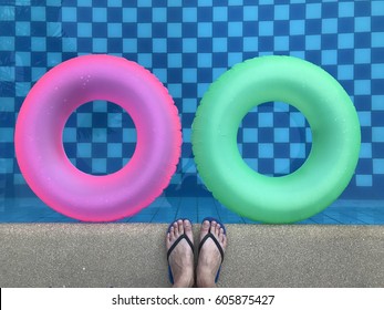 Couple Life Ring In Pool With Foots