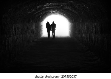 Couple and light in the end of the tunnel. Hope and freedom