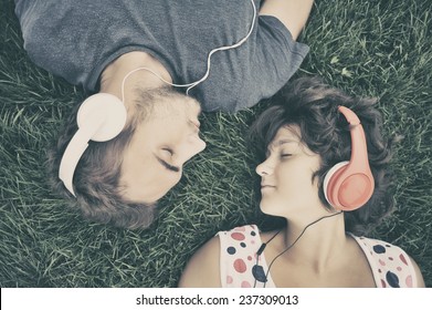 Couple Listening To Music On Headphones