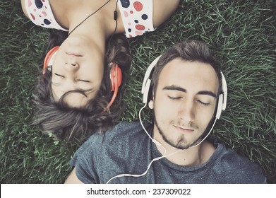 Couple Listening To Music On Headphones