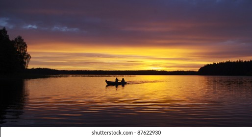 A Couple In A Little Boat During Sunset At Lake Ilgis, Plateliai, Lithuania