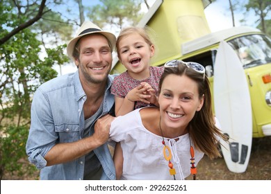 Couple with little girl enjoying vacation in camper van - Powered by Shutterstock