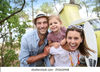 Couple with little girl enjoying vacation in camper van - Powered by Shutterstock