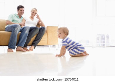 Couple In Living Room With Baby Smiling