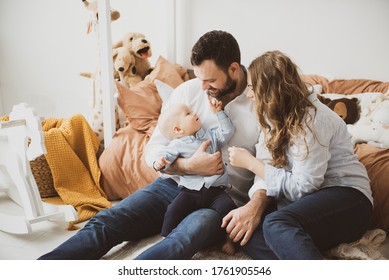 Couple In Living Room With Baby Smiling