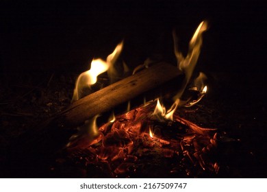 A Couple Logs Burn On A Warm Summer Night