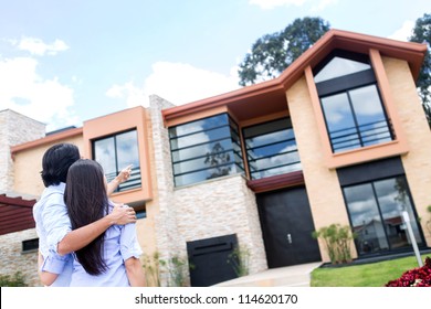 Couple Looking At A Beautiful House To Buy