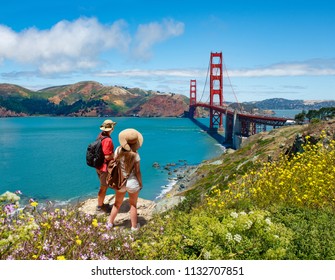 Couple looking at beautiful summer coastal landscape, on hiking trip. Friends  relaxing on mountain. Golden Gate Bridge, over Pacific Ocean and San Francisco Bay, San Francisco, California, USA. - Powered by Shutterstock