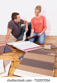 Couple Looking At Carpet Samples.