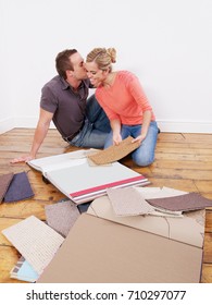 Couple Looking At Carpet Samples