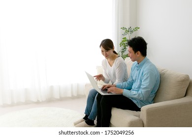 
A Couple Looking At A Computer And Making A Schedule