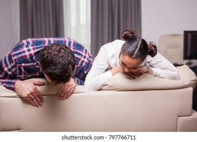 Couple Looking Down At The Back Of A Couch. Love And Familly