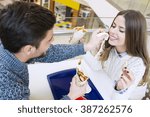 Couple looking at each other while eating fast food.Image taken inside a shopping mall.