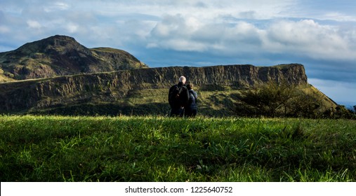 A Couple Looking At The Holyrood Park.