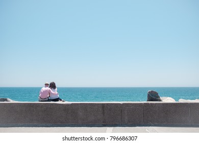 Couple Looking At The Horizon On A Sunny Day In Viña Del Mar