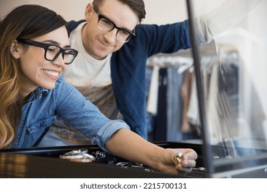 Couple looking at jewelry in shop - Powered by Shutterstock