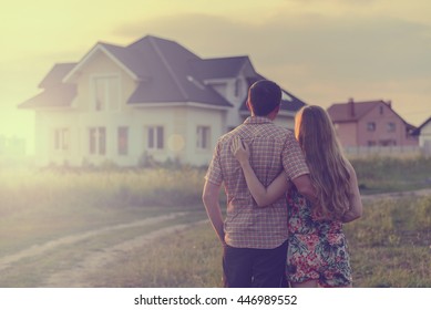 couple looking on house