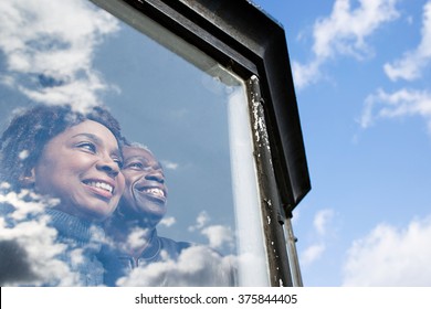 Couple looking out of a window - Powered by Shutterstock