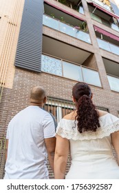 Couple Looking Up Saying Hi To Neighbors And Family