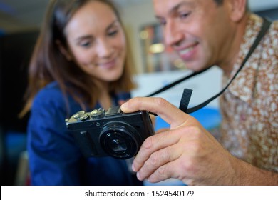 Couple looking at screen of digital camera
