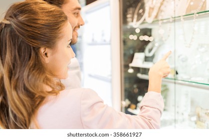 Couple Looking To Shopping Window At Jewelry Store