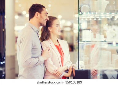 Couple Looking To Shopping Window At Jewelry Store