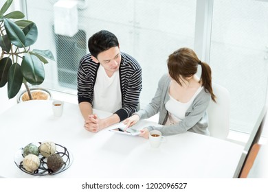 Couple looking at a tablet PC together - Shutterstock ID 1202096527