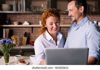 Couple Looking At Tablet And Talking