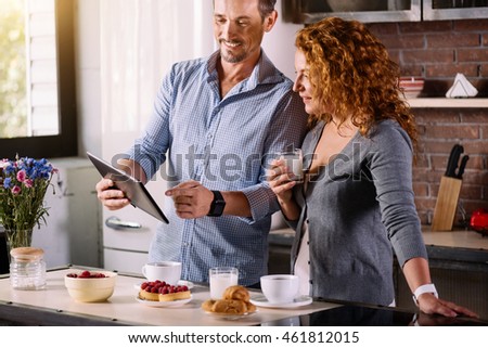Couple looking at tablet while having breakfast
