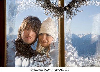 Couple Looking Through Frosty Window