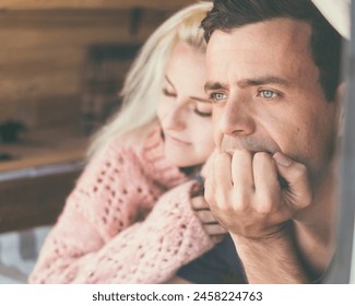 Couple in love with adult man looking ahead and thoughtful and blonde young girl hugged to him. Different age relationship people boy and girl. Love and problems. Relax laying on bed inside cabin - Powered by Shutterstock
