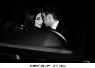 Couple in love in a black car