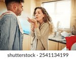 Couple, love and blowing flour in kitchen, romance and playing with ingredient, fun and bonding in home. Baking, woman and happy with man, date and games with food, marriage and meal prep in house