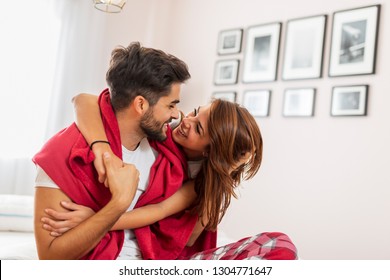 Couple In Love Cuddling And Hugging In Bed After Waking Up