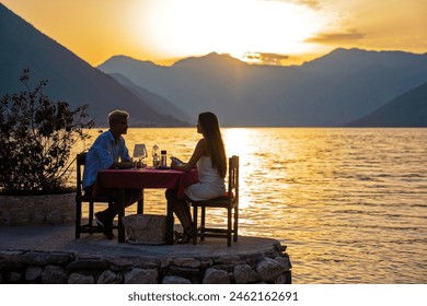 Couple in love drinking wine on romantic dinner at sunset on the beach. People love travel concept - Powered by Shutterstock