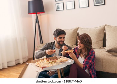 Couple in love eating pizza for lunch and having fun - Powered by Shutterstock