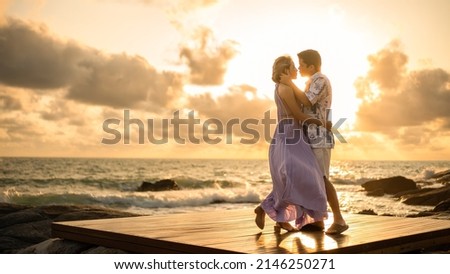 Similar – Image, Stock Photo Romantic moment with a couple sharing a strawberry on a rooftop